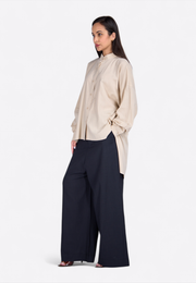 Model wearing long hem shirt, front-side pose – East Vibe